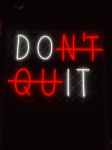 a neon sign that says don t quit
